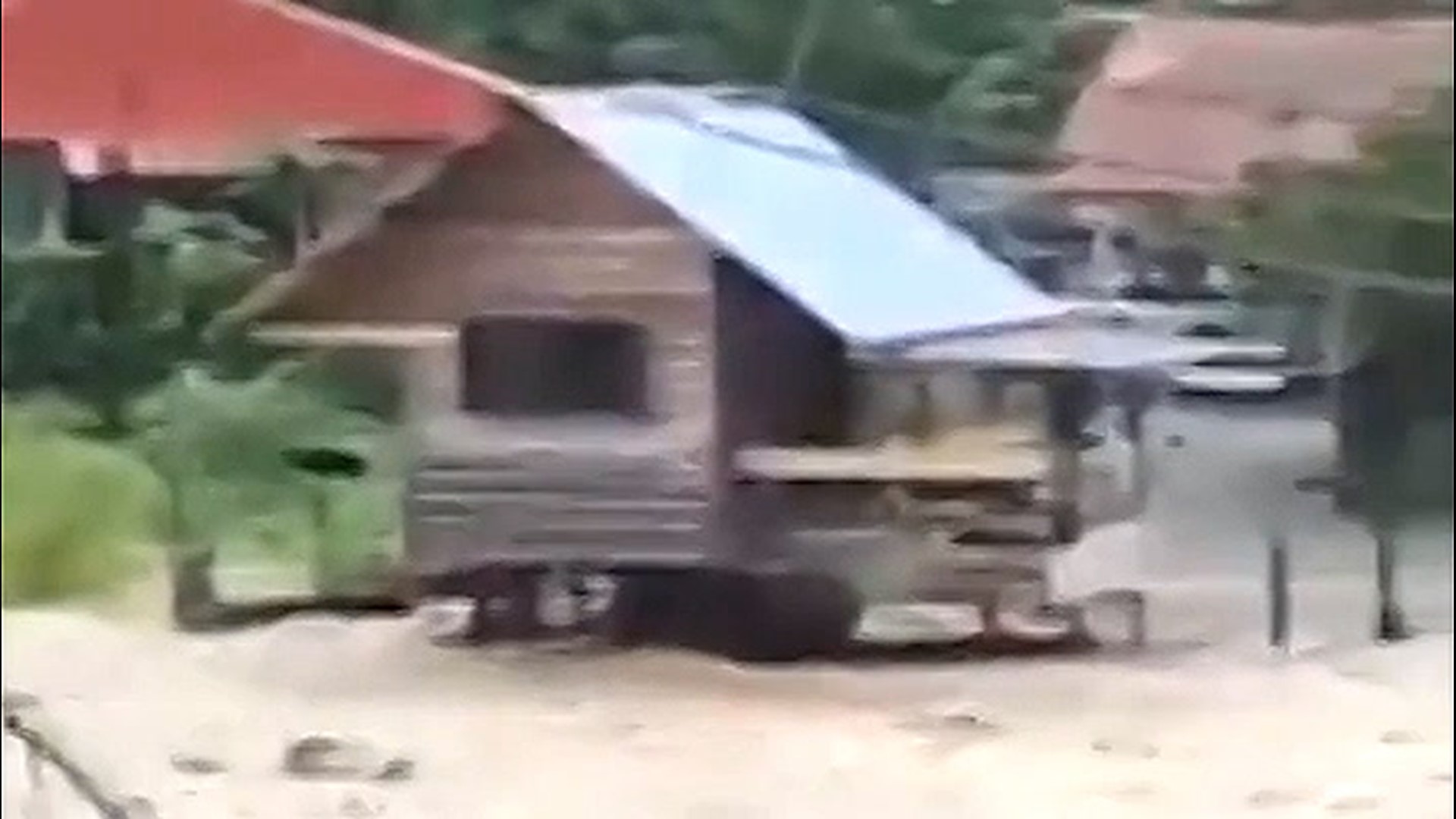 At least six fatalities were reported and thousands of people were displaced after heavy rainfall triggered flooding in Malaysia on Jan. 17. Severe flooding rages below this bridge in Kota Belud.