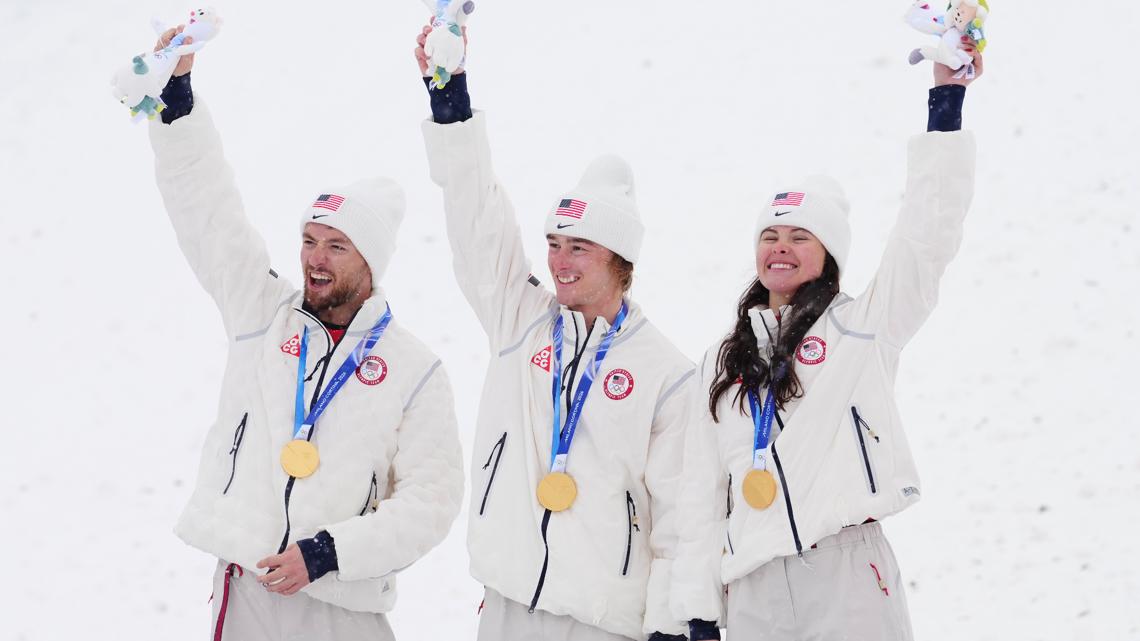 Team USA's Christopher Lillis, Connor Curran and Kaila Kuhn win gold in freestyle ski mixed team aerials at the Olympics in Italy, Feb. 21, 2026.