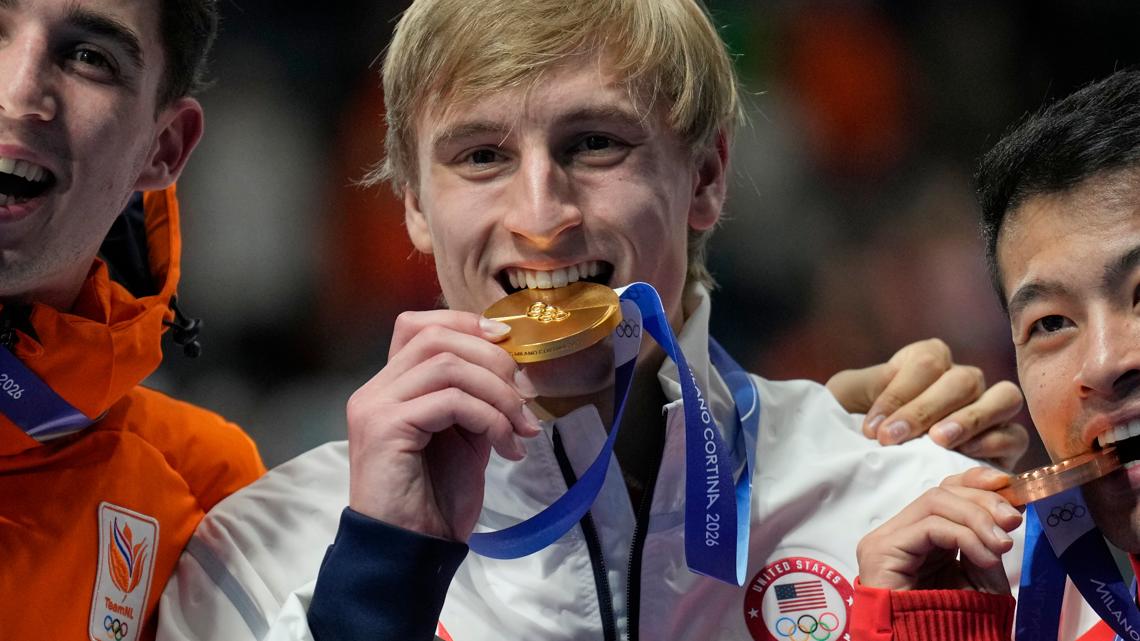 Gold medalist Jordan Stolz, center, Jenning de Boo, left, and Ning Zhongyan, right celebrate the men's 1,000m speedskating race at the 2026 Olympics.