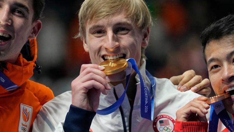 Gold medalist Jordan Stolz, center, Jenning de Boo, left, and Ning Zhongyan, right celebrate the men's 1,000m speedskating race at the 2026 Olympics.