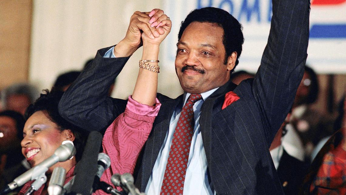 FILE - Democratic presidential hopeful Jesse Jackson with his wife, Jacqueline, salutes cheering crowd at Operation Push in Chicago, March 10, 1988.
