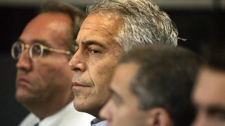 FILE - In this July 30, 2008, file photo, Jeffrey Epstein, center, appears in court in West Palm Beach, Fla.
