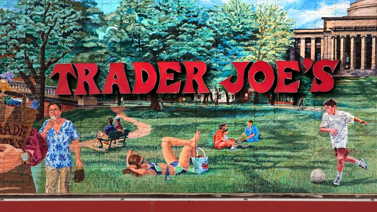 FILE - The Trader Joe's logo hangs on a mural, Aug. 13, 2019, in Cambridge, Mass.