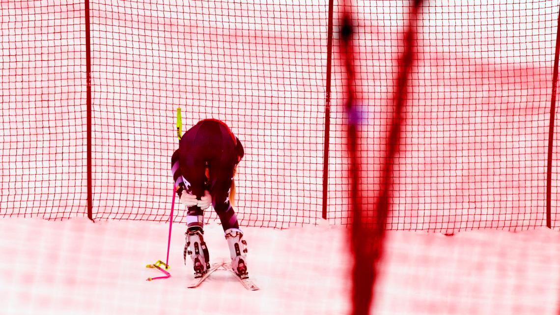 Lindsey Vonn holds her left knee after crashing, during an alpine ski, women’s World Cup downhill, in Crans Montana, Switzerland, Jan. 30, 2026.