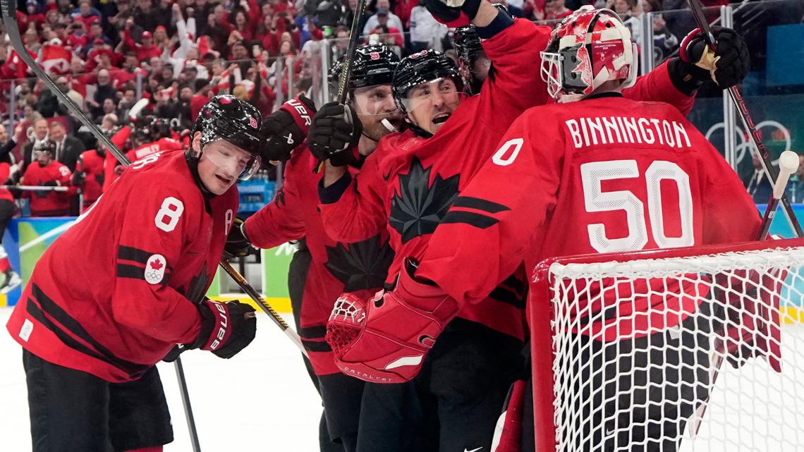 Canada players celebrate at the end of a men's ice hockey semifinal game between Canada and Finland at the Olympics in Italy, Feb. 20, 2026.