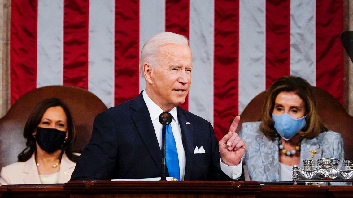 What is the silver thing in front of Nancy Pelosi at Biden speech