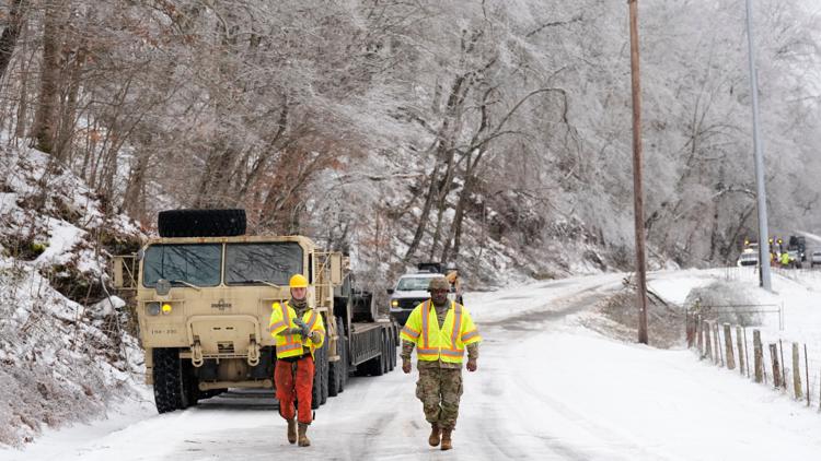 Tennessee National Guard members Taylor Osteen and Antuwan Powell work to remove trees, Jan. 30, 2026, in Nashville, Tenn.