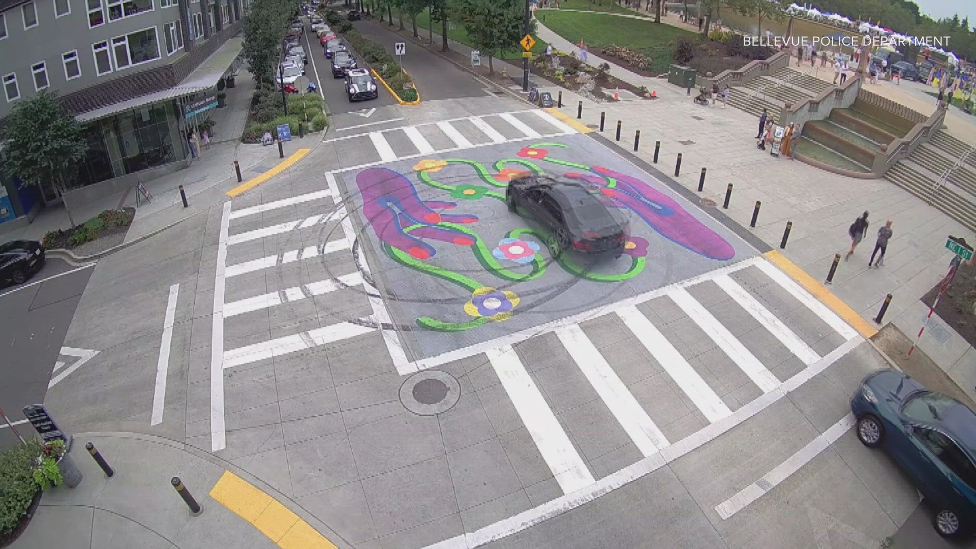 Bellevue police are searching for a man driving a gray BMW with no license plate who vandalized a piece of Pride art by doing donuts in the middle an intersection