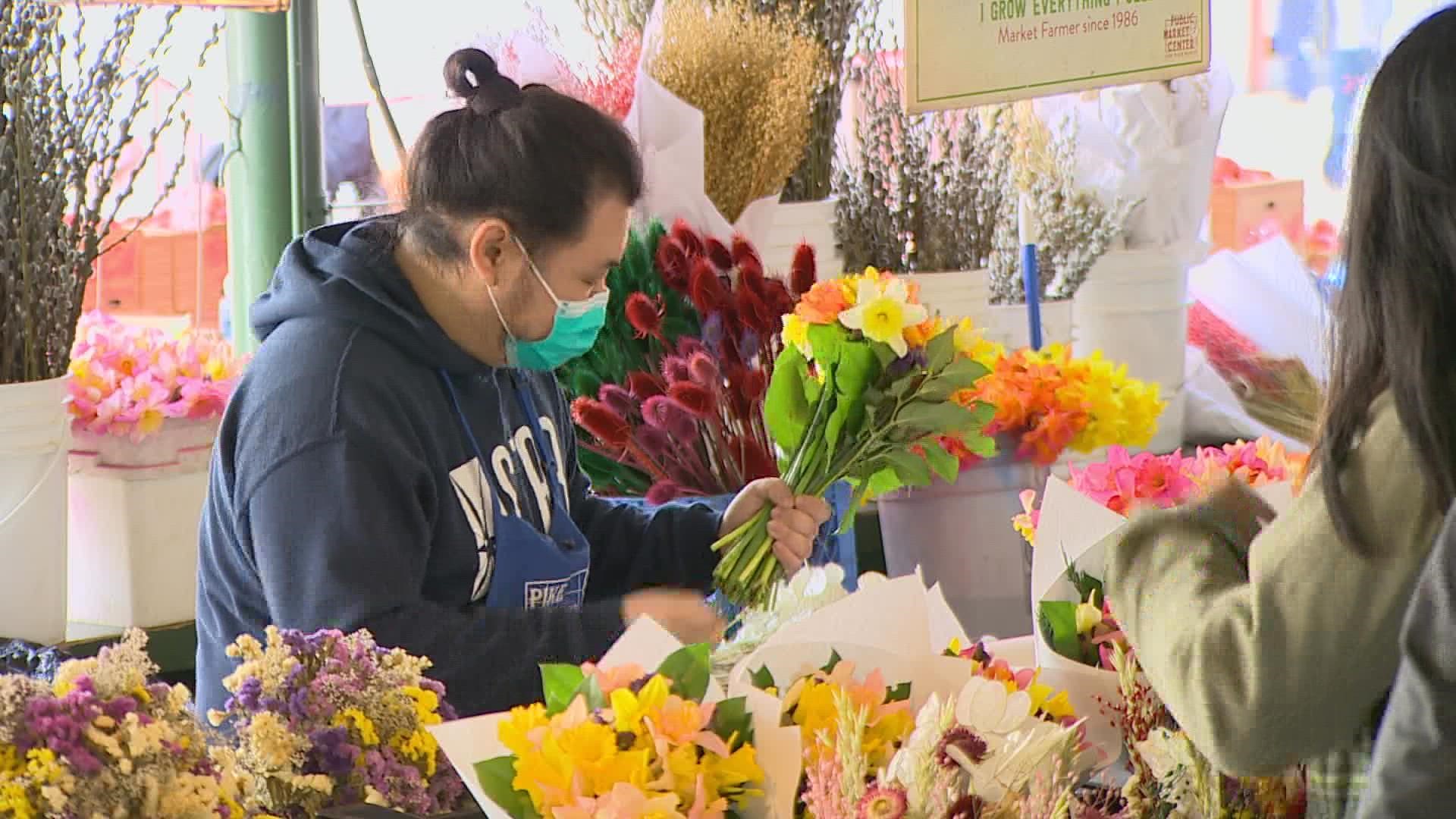 A crowd of both maskless and masked faces packed Seattle's Pike Place Market on Saturday as people enjoyed and the first full day without an indoor mask mandate.