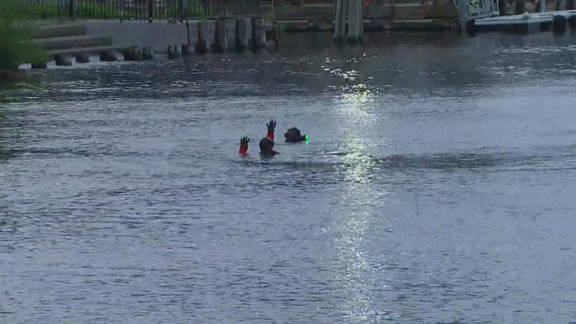 Rescue divers are searching the waters under Ship Canal Bridge for one of the drivers involved in a two-vehicle crash