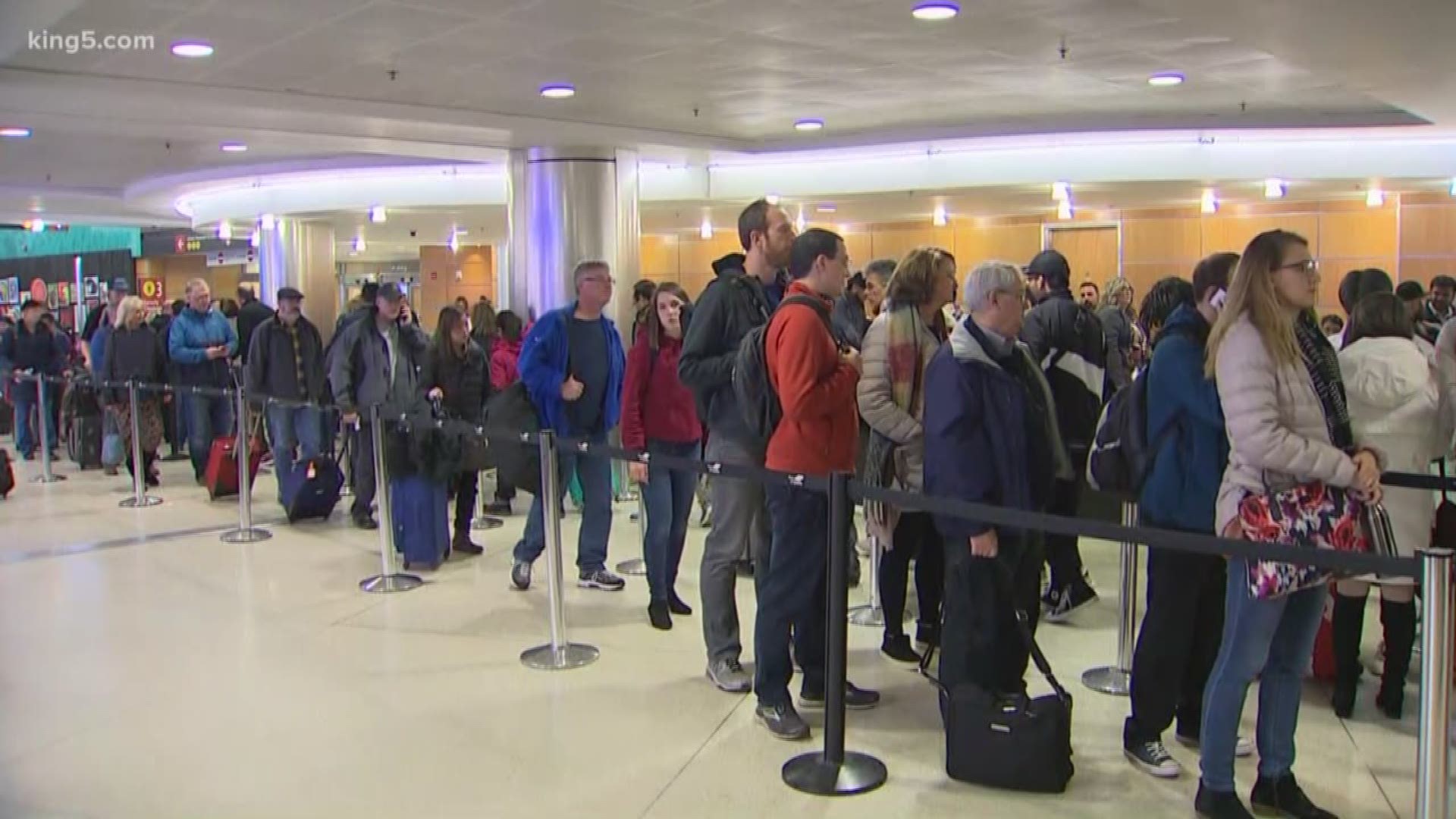 It's a mad house at Sea-Tac Airport on Friday with huge crowds of travelers trying to get out of town ahead of a snowstorm.