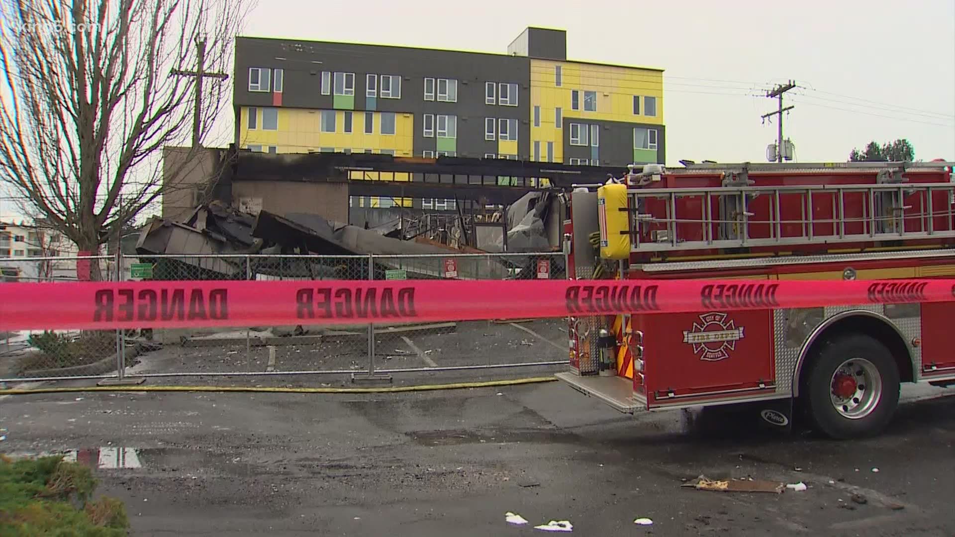 Seattle police said a caller reported seeing people flee after a break-in at a Lake City strip mall just before a two-alarm fire broke out.