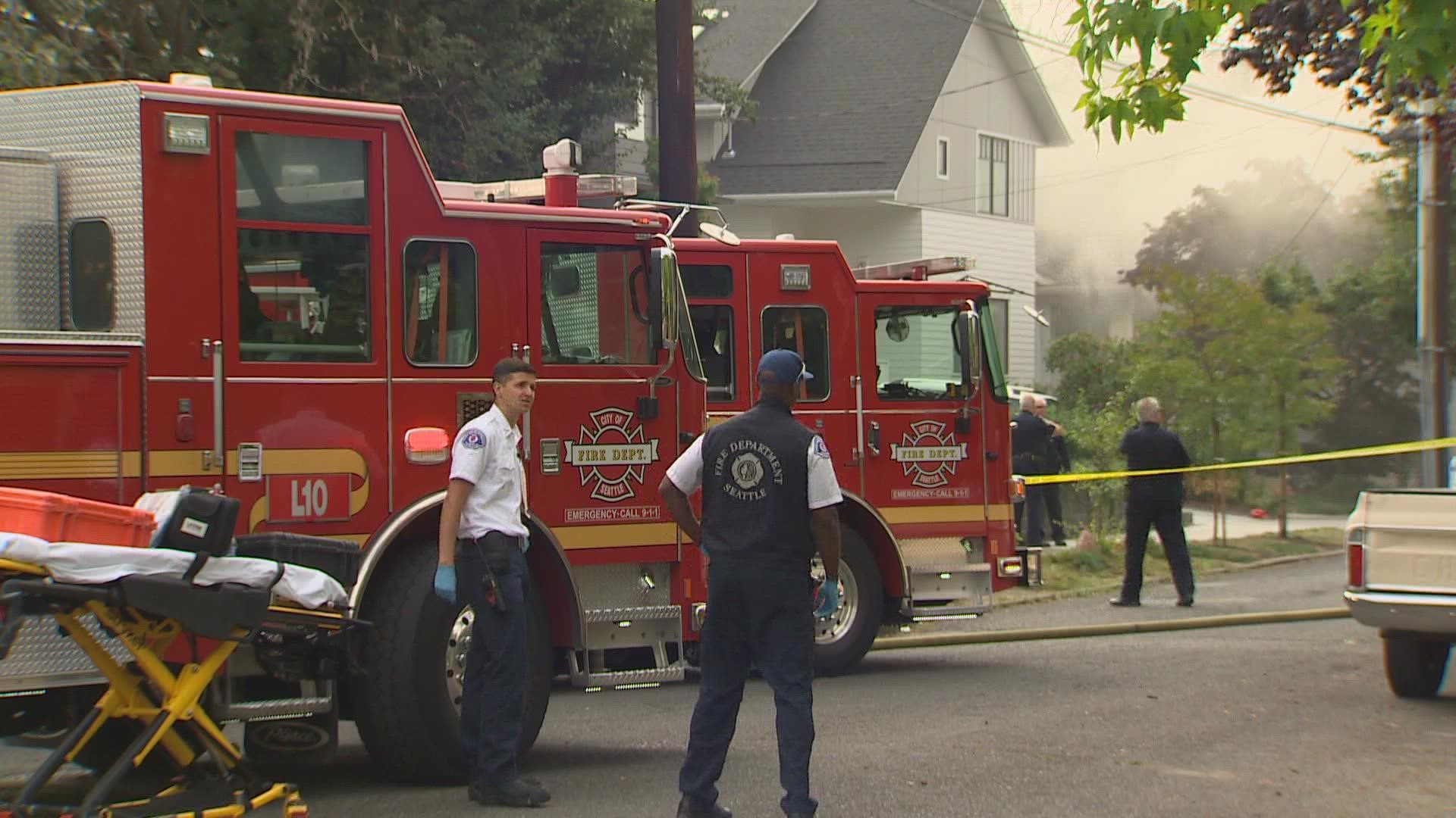 2 people were found dead in a Montlake neighborhood house fire after police say a suspect tried to stab officers.
