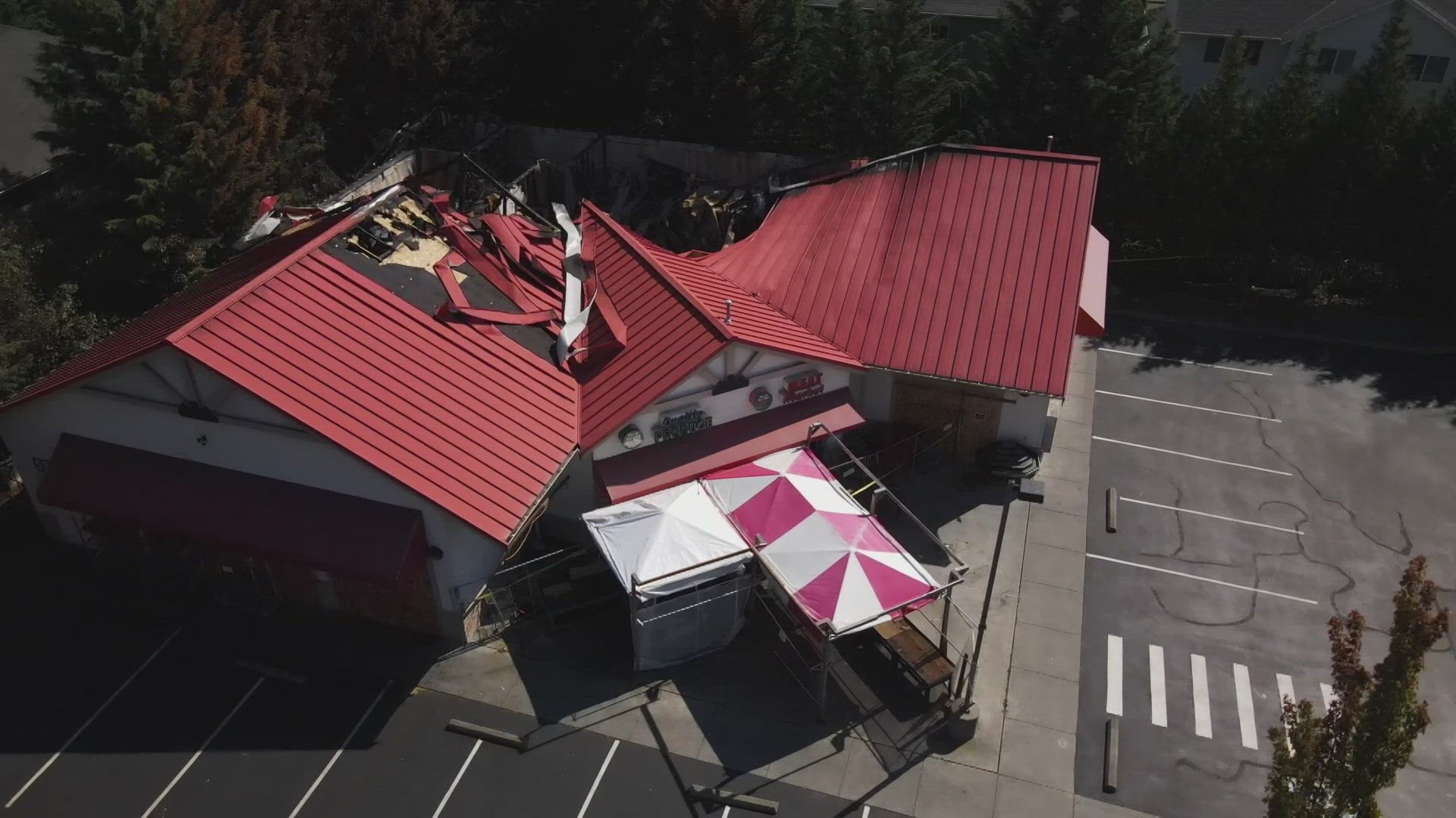 Police continue to investigate the arson at Top of the Hill Produce grocery store in Renton last week.