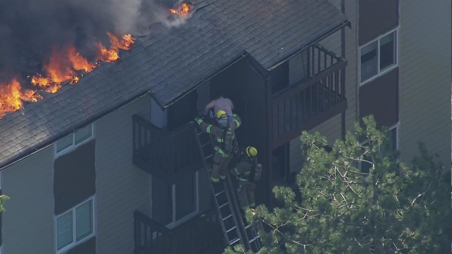 Firefighters rescued two people as a three-alarm fire tore through a Federal Way apartment building Wednesday afternoon.