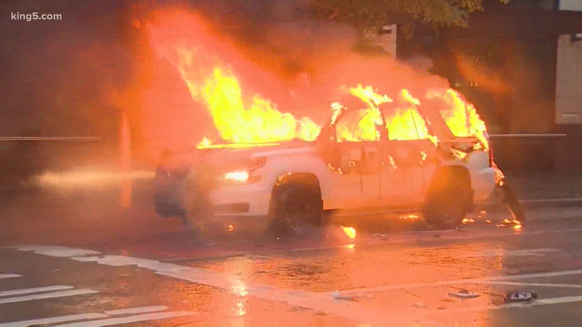 Several Seattle police and city vehicles were set on fire during violent and chaotic protests after a rally for George Floyd on Saturday.