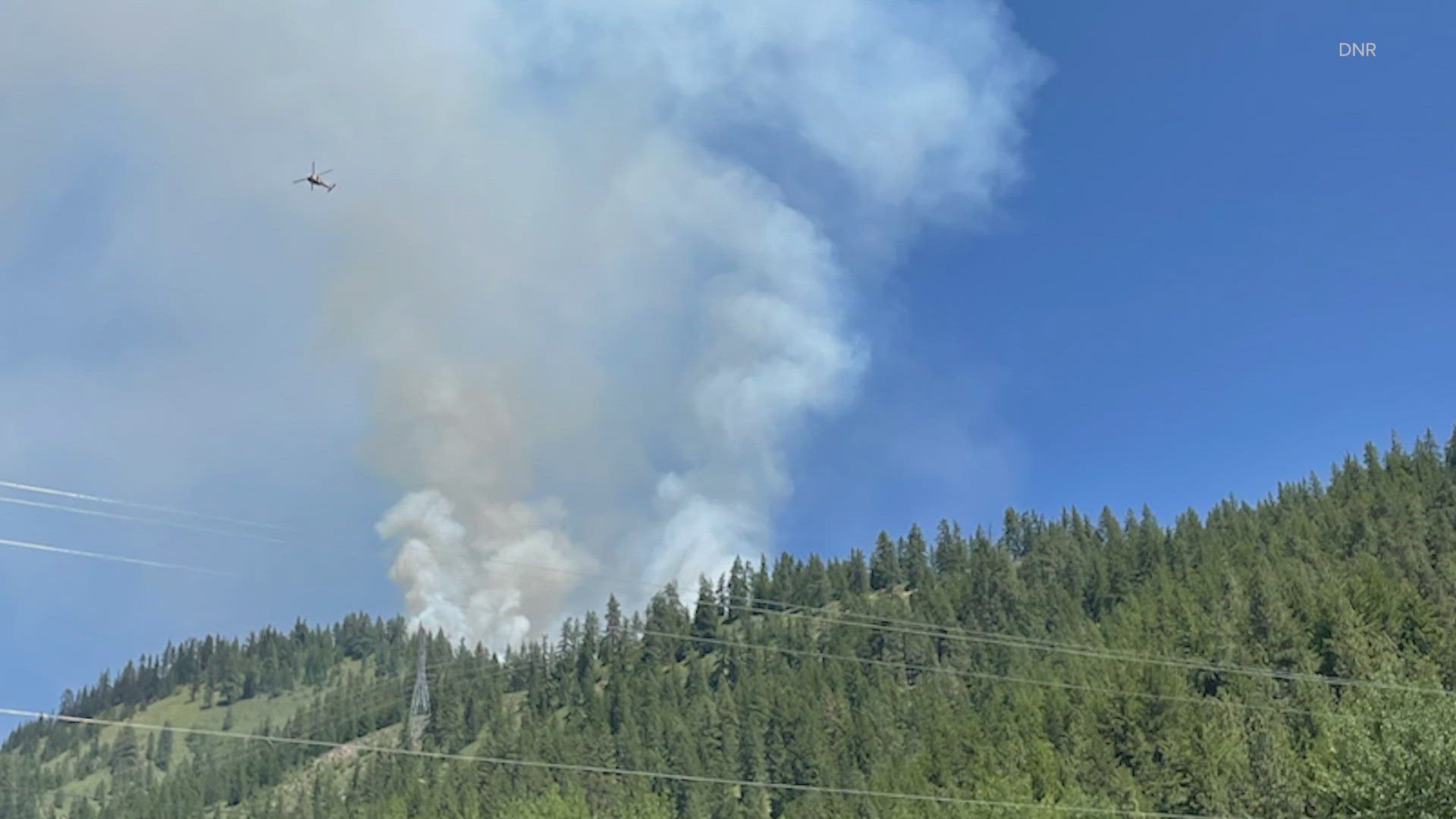 Firefighters are working to contain a wildfire that has burned an estimated 153 acres about eight miles north of Leavenworth.