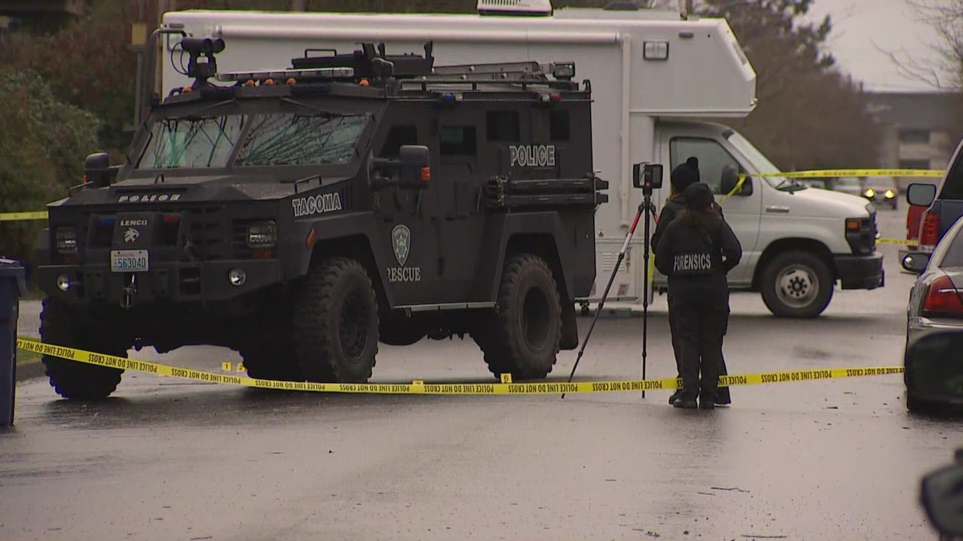 A female suspect who pointed a gun at her neighbor and police in Tacoma was shot and killed by SWAT team members. All officers were reported to be OK.