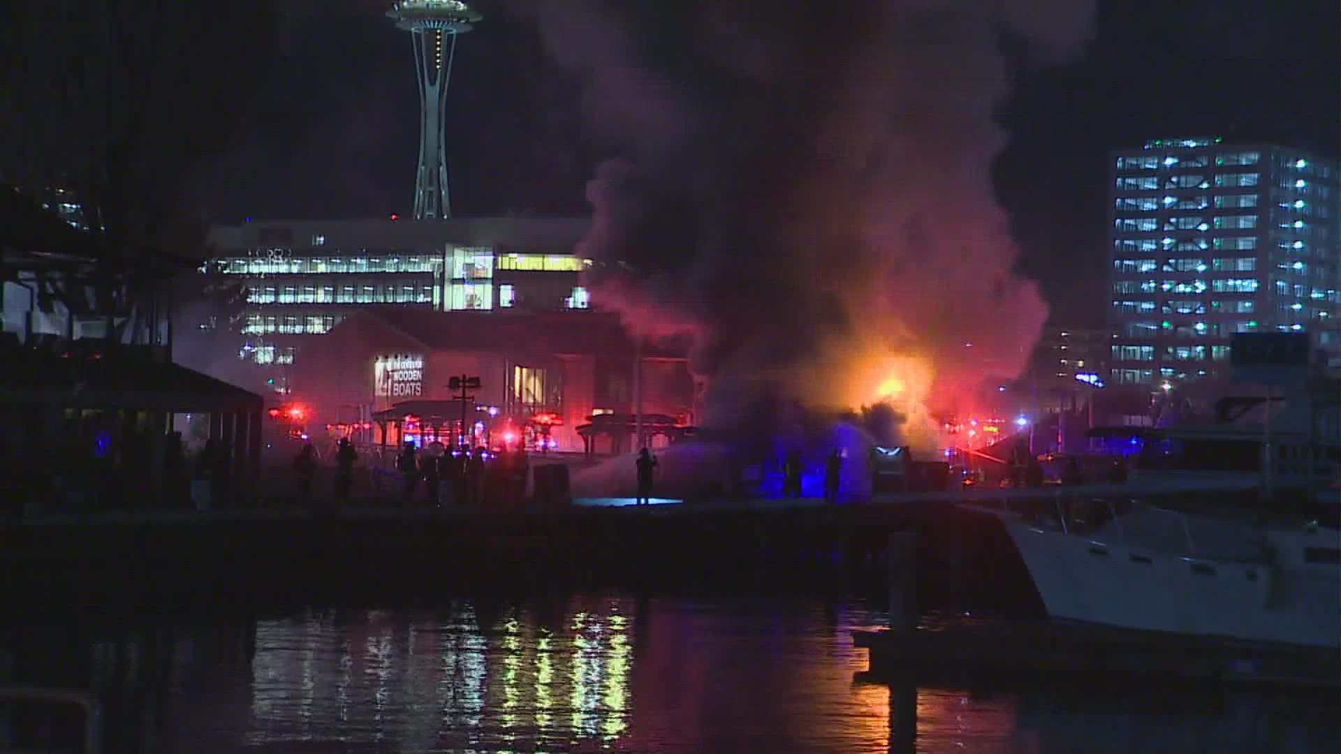 Seattle firefighters are investigating what sparked a large boat fire on Lake Union early Saturday morning.