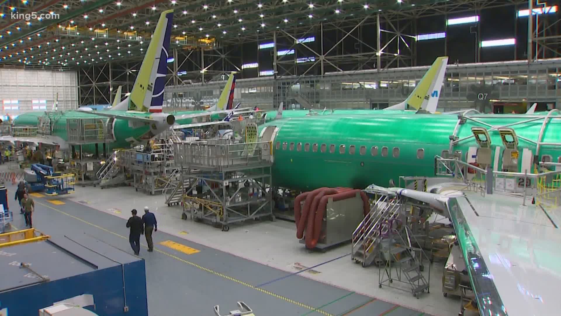 Boeing is cutting about 10% of its workforce and slowing production of planes to deal with a downturn in business.