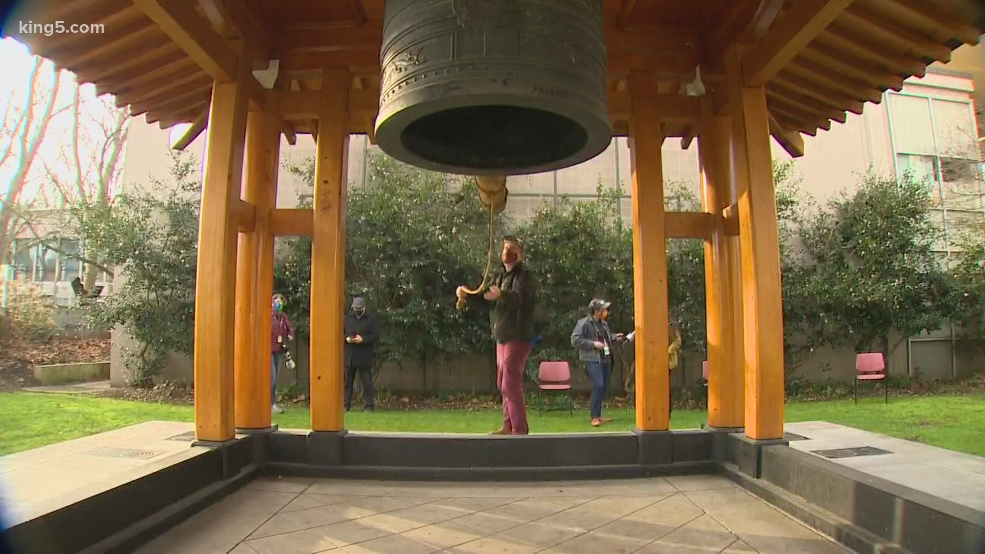 As part of nationwide memorial Tuesday to honor lives lost to COVID-19, the Kobe Bell at Seattle Center was rung and buildings in downtown Seattle are illuminated.