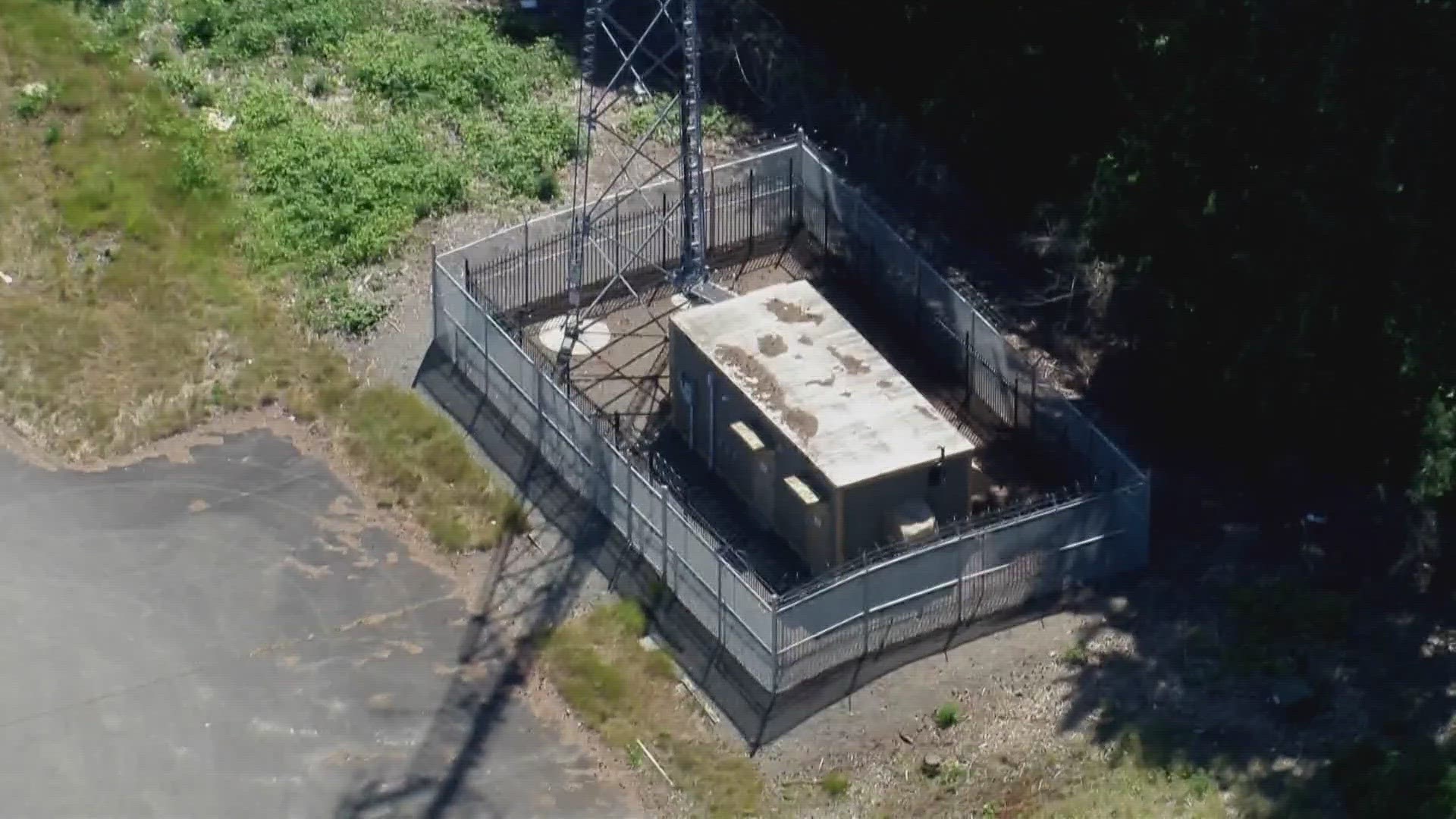 The vault supplies a tower that is believed to provide communications for South Sound 911. Police found a grinding tool and one man was armed with a gun.