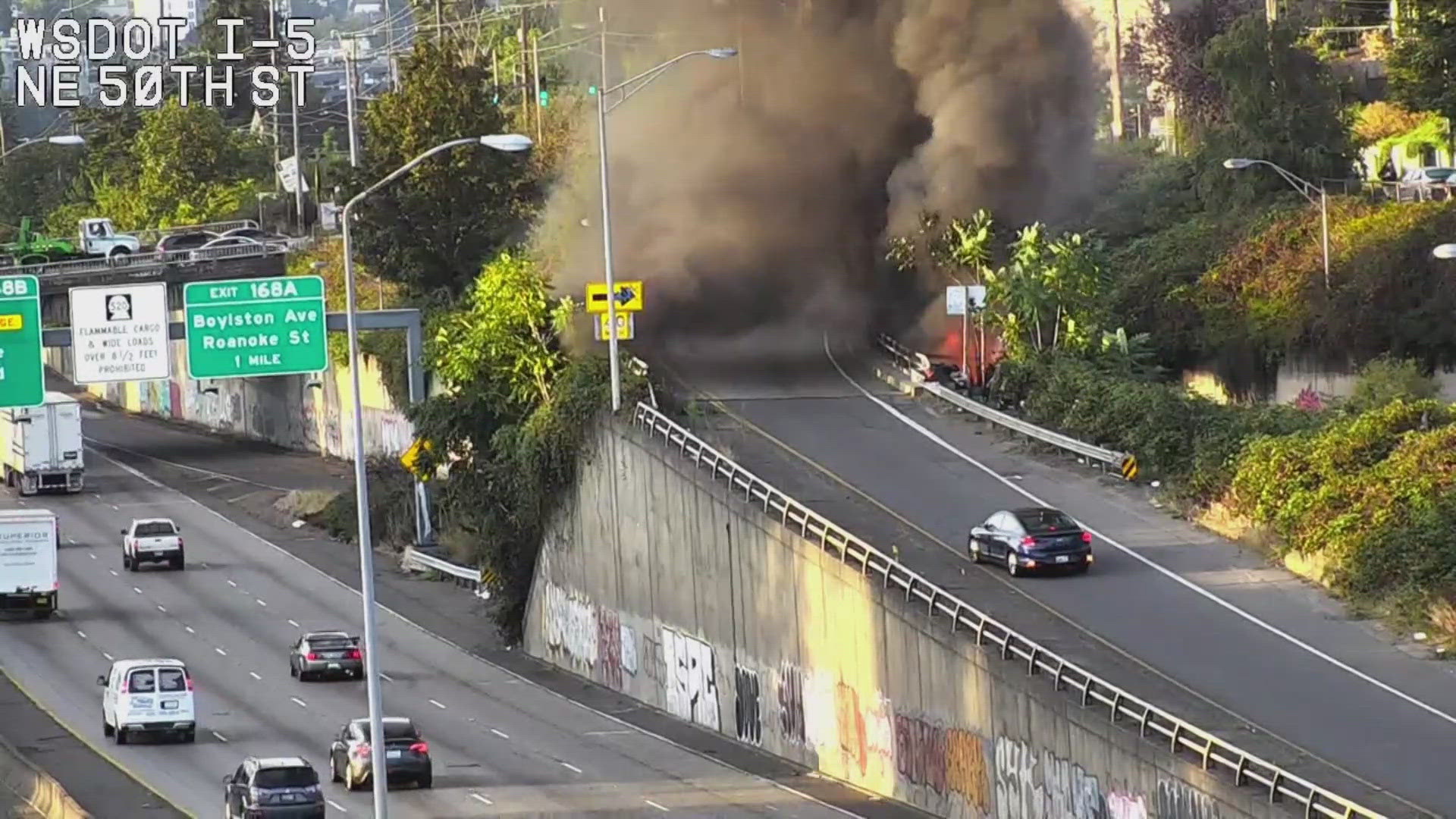 Crews are investigating what caused a fire under an I-5 off-ramp in north Seattle Saturday morning.