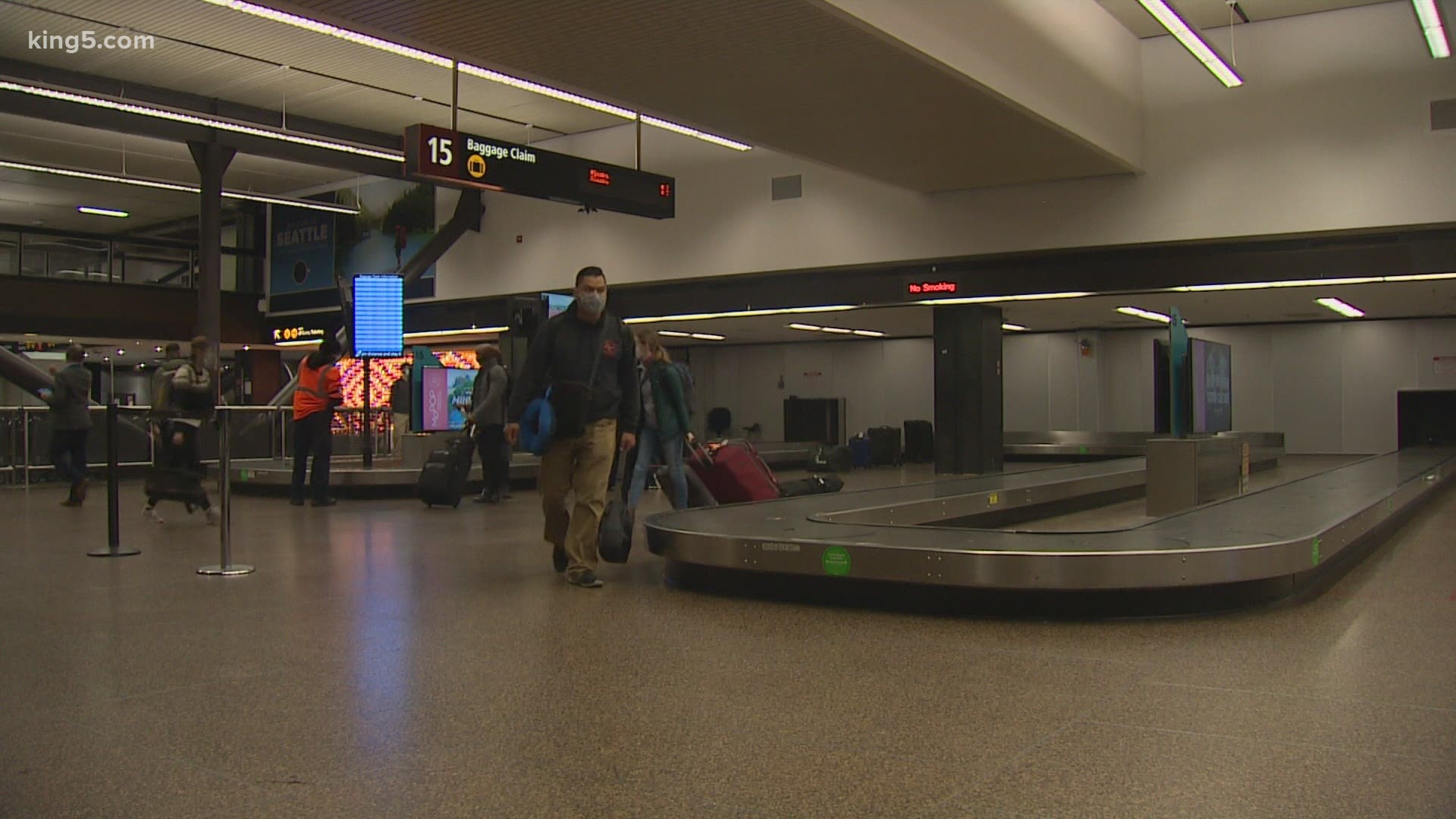 Far fewer passengers are traveling through Sea-Tac Airport this holiday as travel warnings stretch from Washington state around the country.