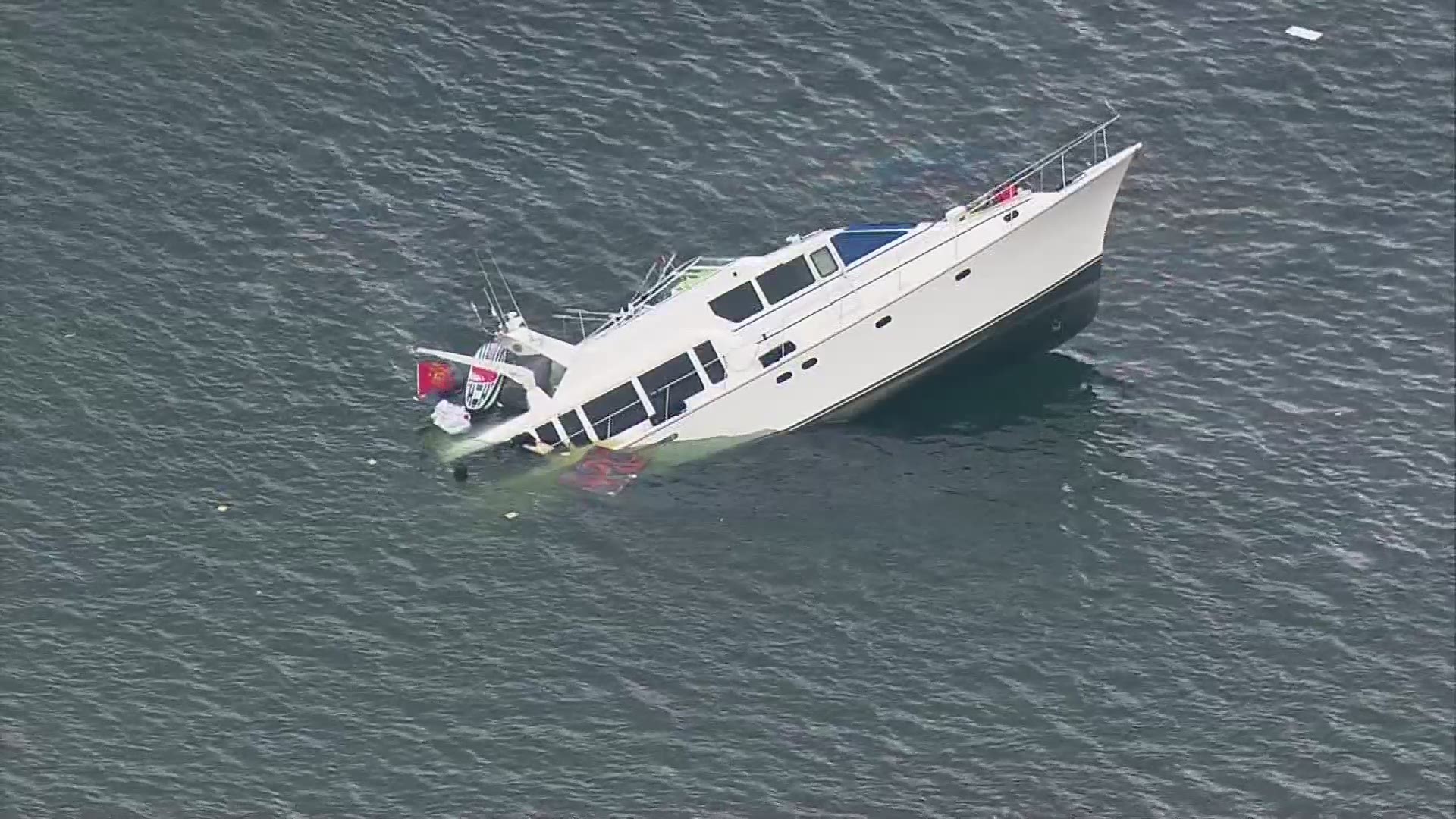 65-foot boat started sinking 1.3 miles SW of the Hood Canal Bridge. The Coast Guard says 8 people self-rescued from the boat's dinghy and made it safely to shore. The Coast Guard attempted to "de-water" the boat, but now say the yacht is expected to sink in 1,080 feet of water.