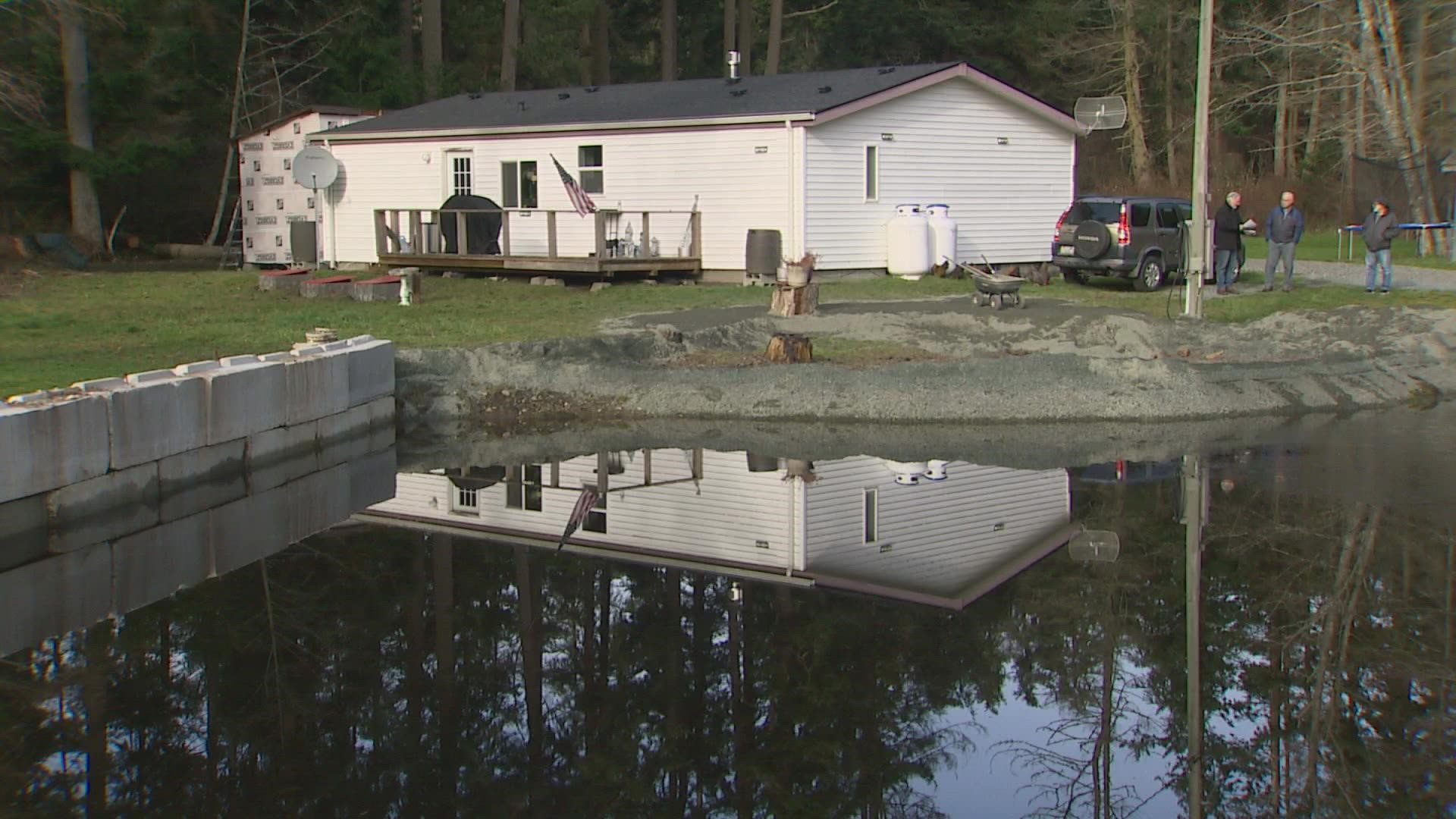 The disabled couple says Island County won't pay to fix an outdated drainage system flooding their property.