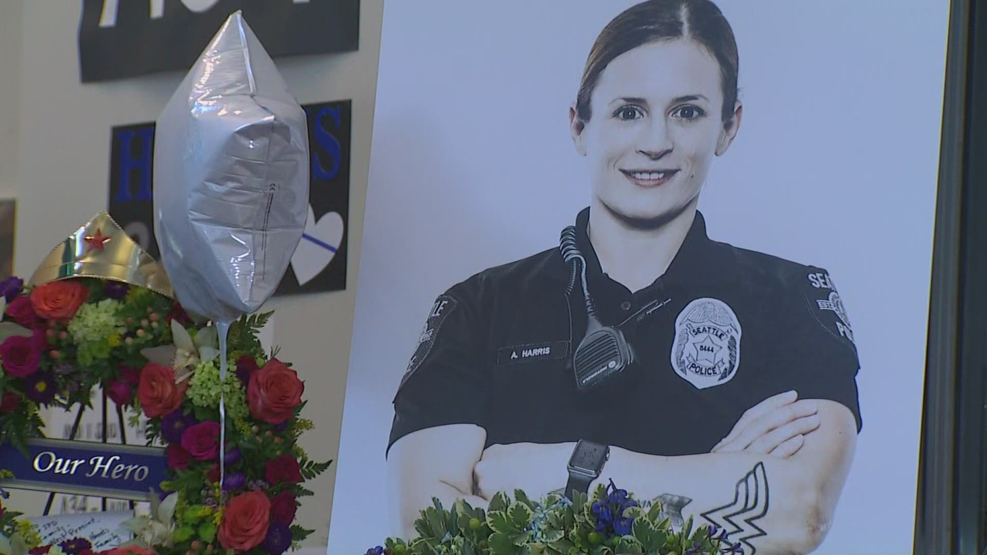 The suspect allegedly stole the car of an off-duty Seattle police officer after she was hit and killed while helping with a three-car pile-up on Interstate 5.