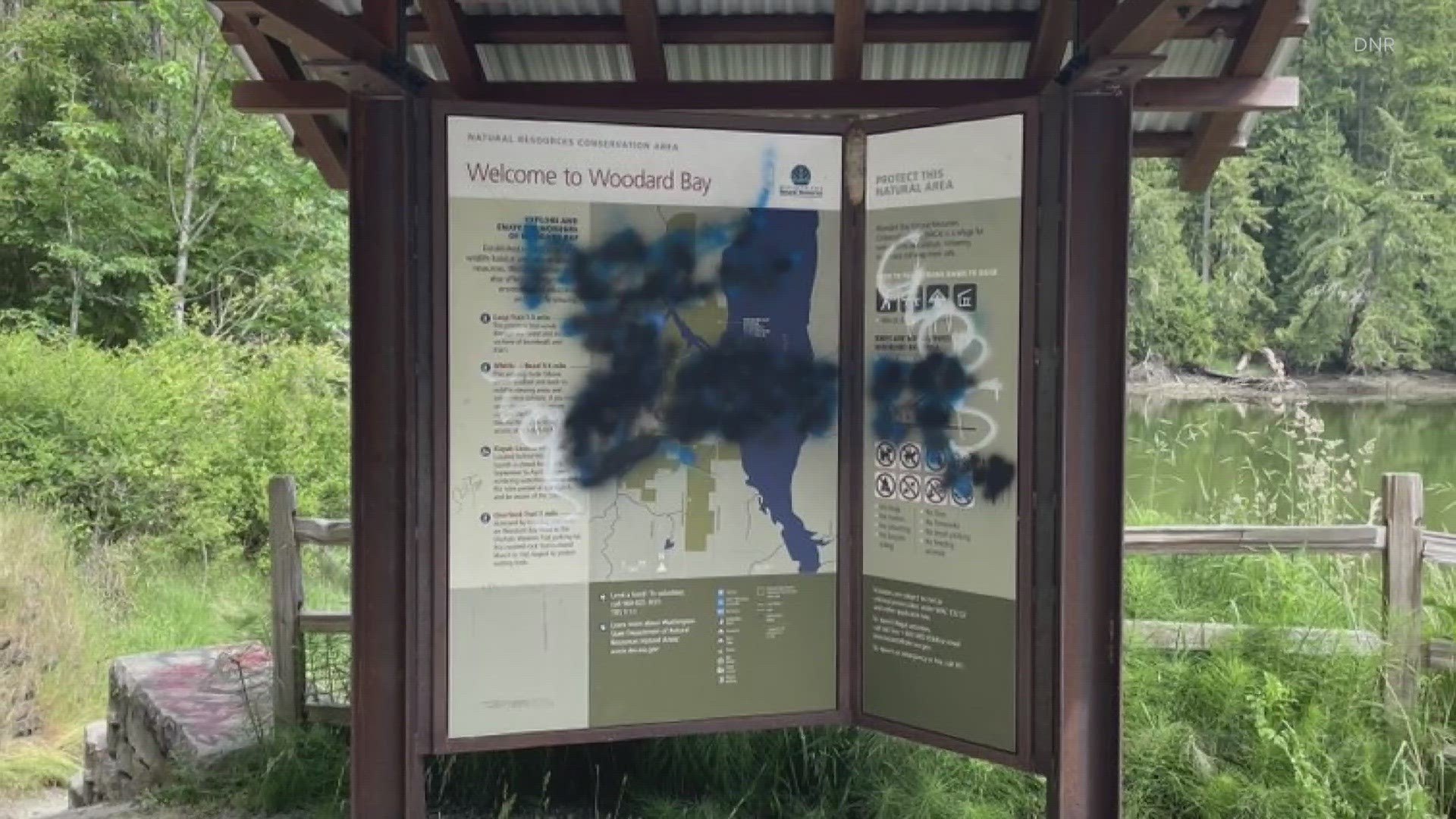 The state Department of Natural Resources says some signs at Woodard Bay conservation area in Olympia were vandalized with hateful images and words on Sunday