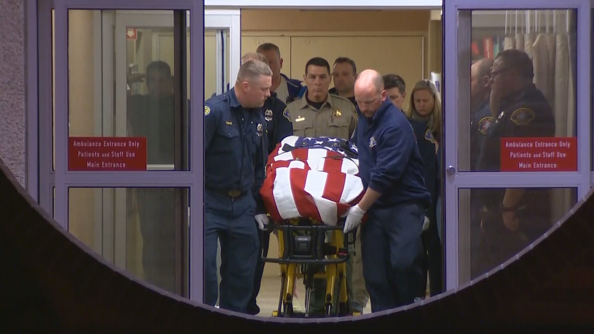 A fallen Kittitas County deputy is saluted and escorted by fellow officers following a fatal shootout with a suspect.