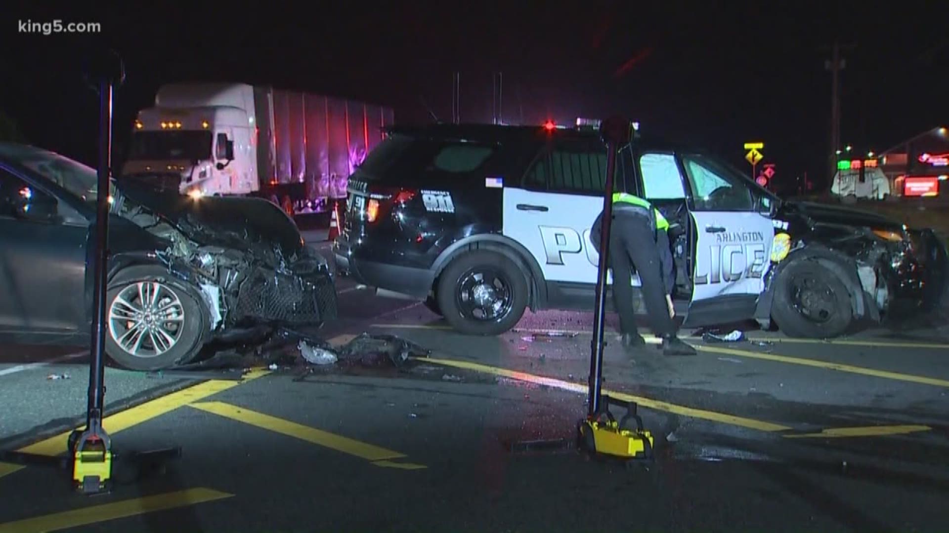 A 23-year-old woman was arrested for DUI Thursday morning after police say she crashed into an Arlington police vehicle, sending two officers to the hospital.