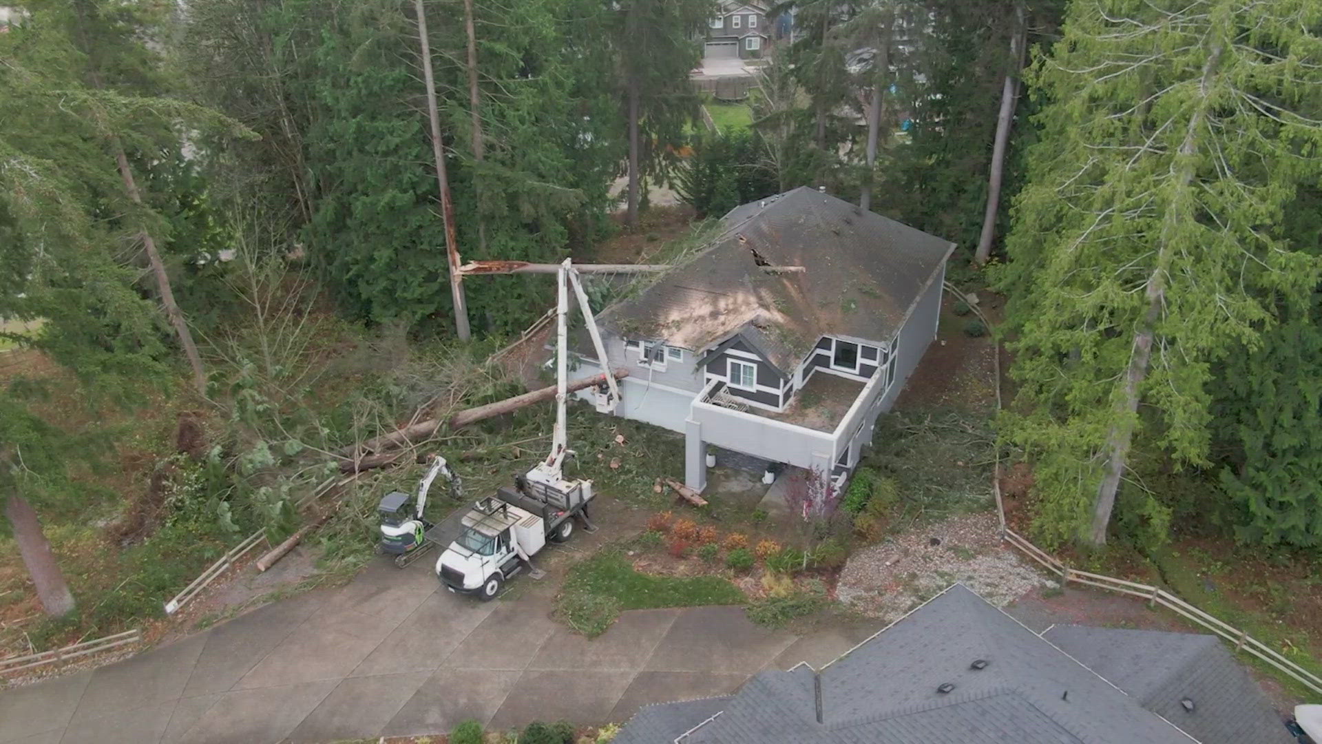 Dozens of trees and power poles remain down. Thousands remain without power.