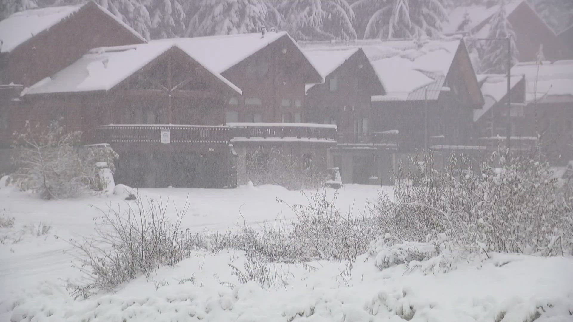 Traction tires are advised over Snoqualmie Pass as snow and slush continue to build