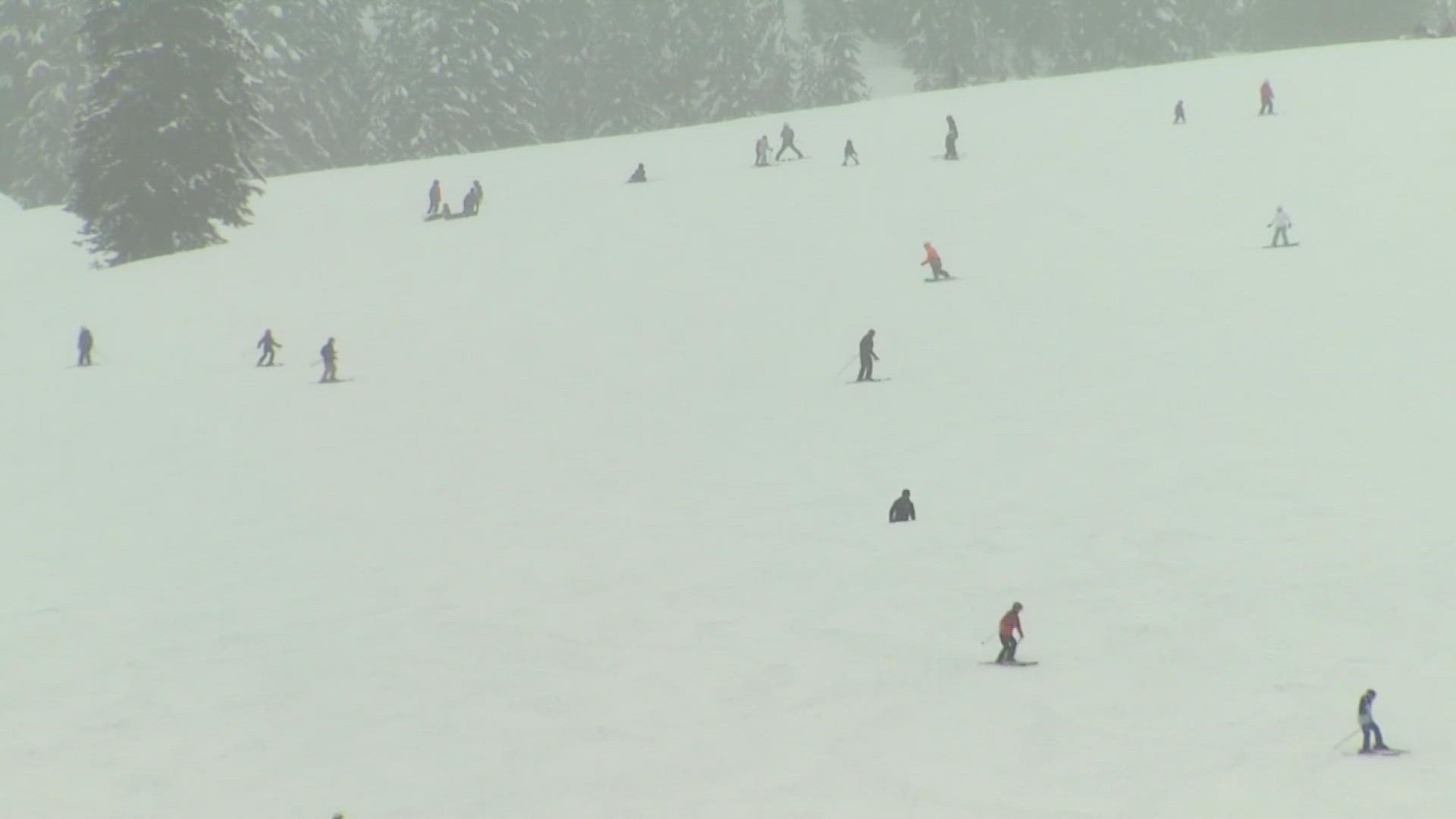 Heavy snow is expected over the mountains through Tuesday, bringing over a foot to Snoqualmie and Stevens passes.