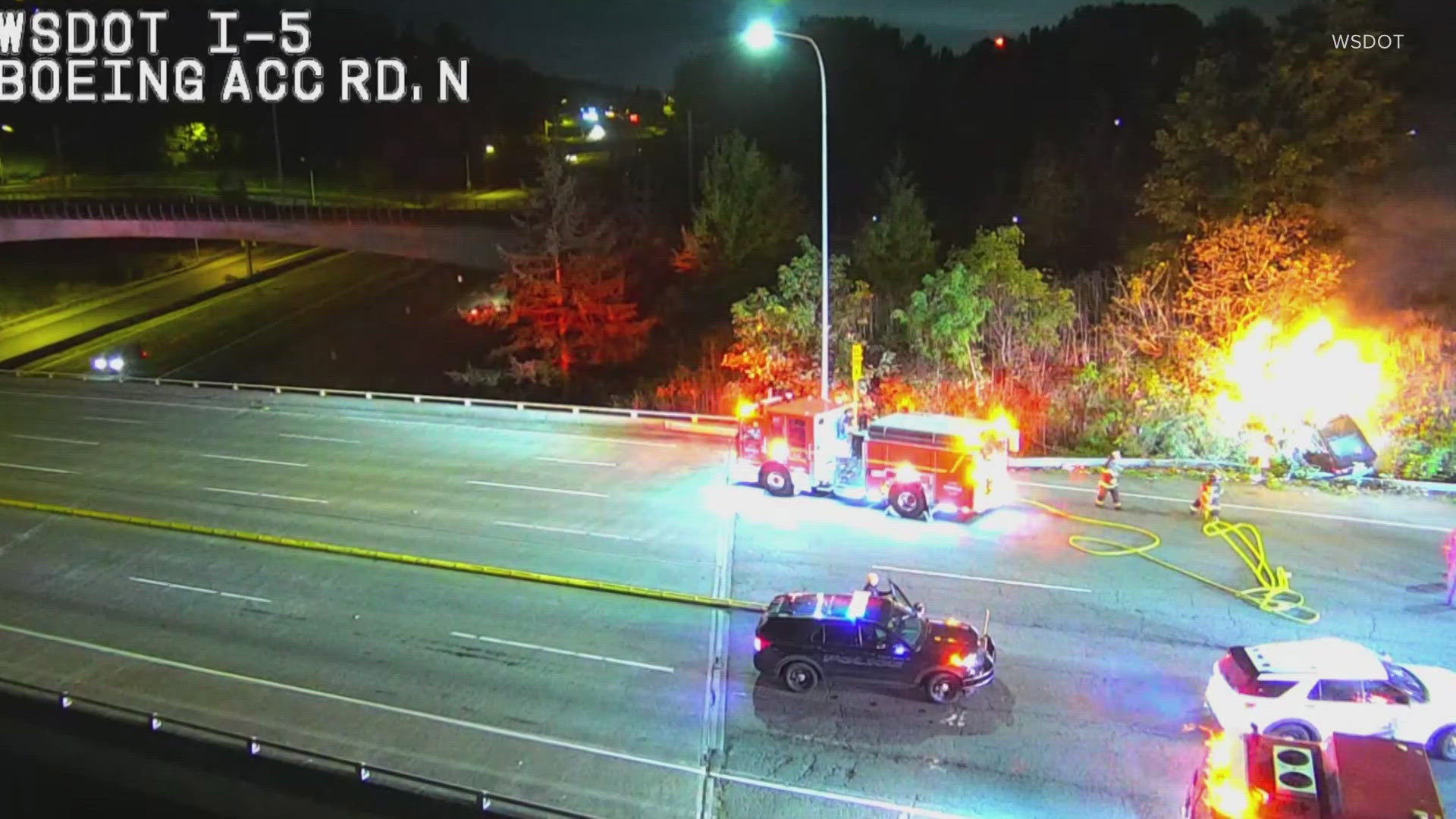 A crashed car burst into flames off the side of I-5 near Boeing Access Rd. Wednesday morning