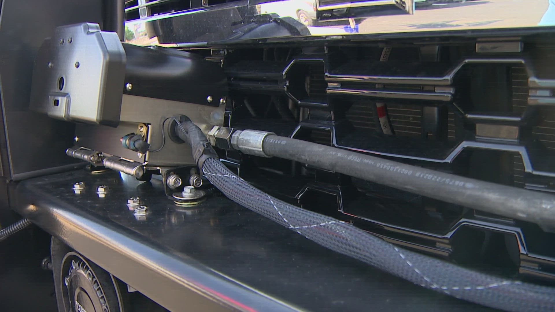 At the press of a button, a small air compressor inside the squad car’s engine bay can propel a GPS tracker through the air and onto the back of a suspect’s vehicle.