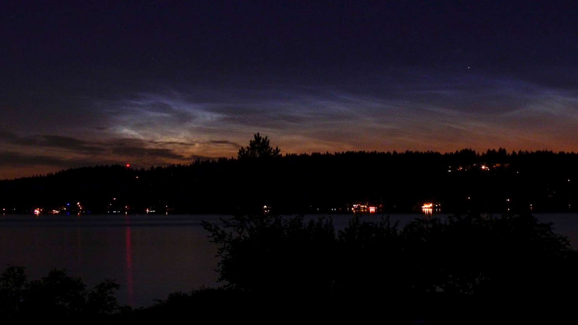 Noctilucent clouds are clouds that are high in the atmosphere and illuminated by the sun on the other side of the planet. They tend to be seen around the summer solstice.