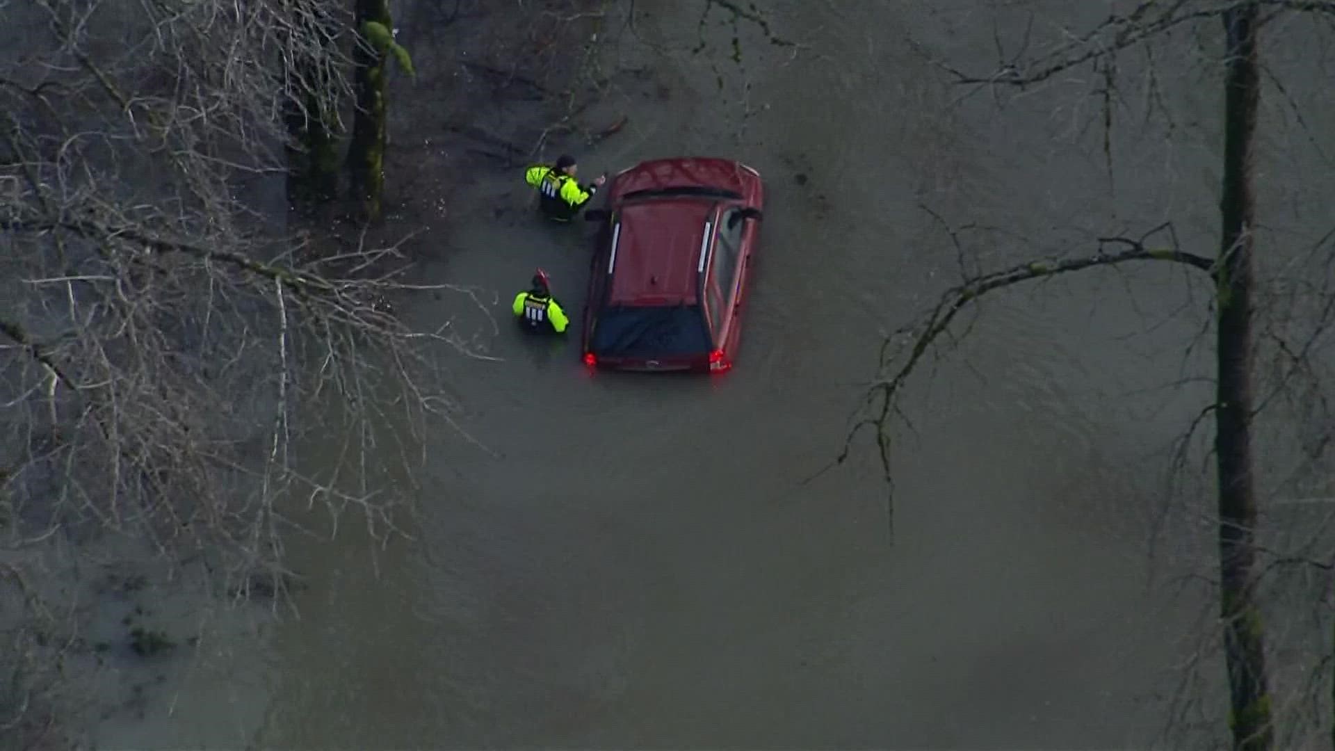 Two suspects carjacked a woman, fought with officers, and rammed a patrol vehicle before crashing into a river near Fall City.