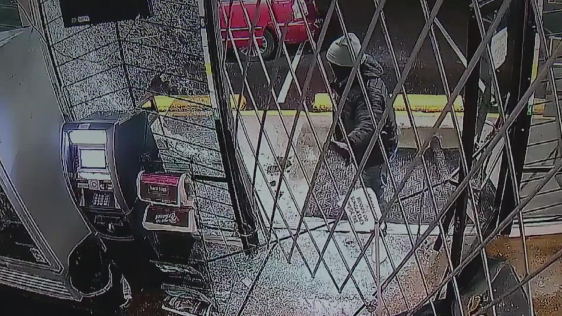 Security video shows two burglars at Dank's Wonder Emporium trying to first break in with a sledgehammer and then using their minivan to ram the front windows.