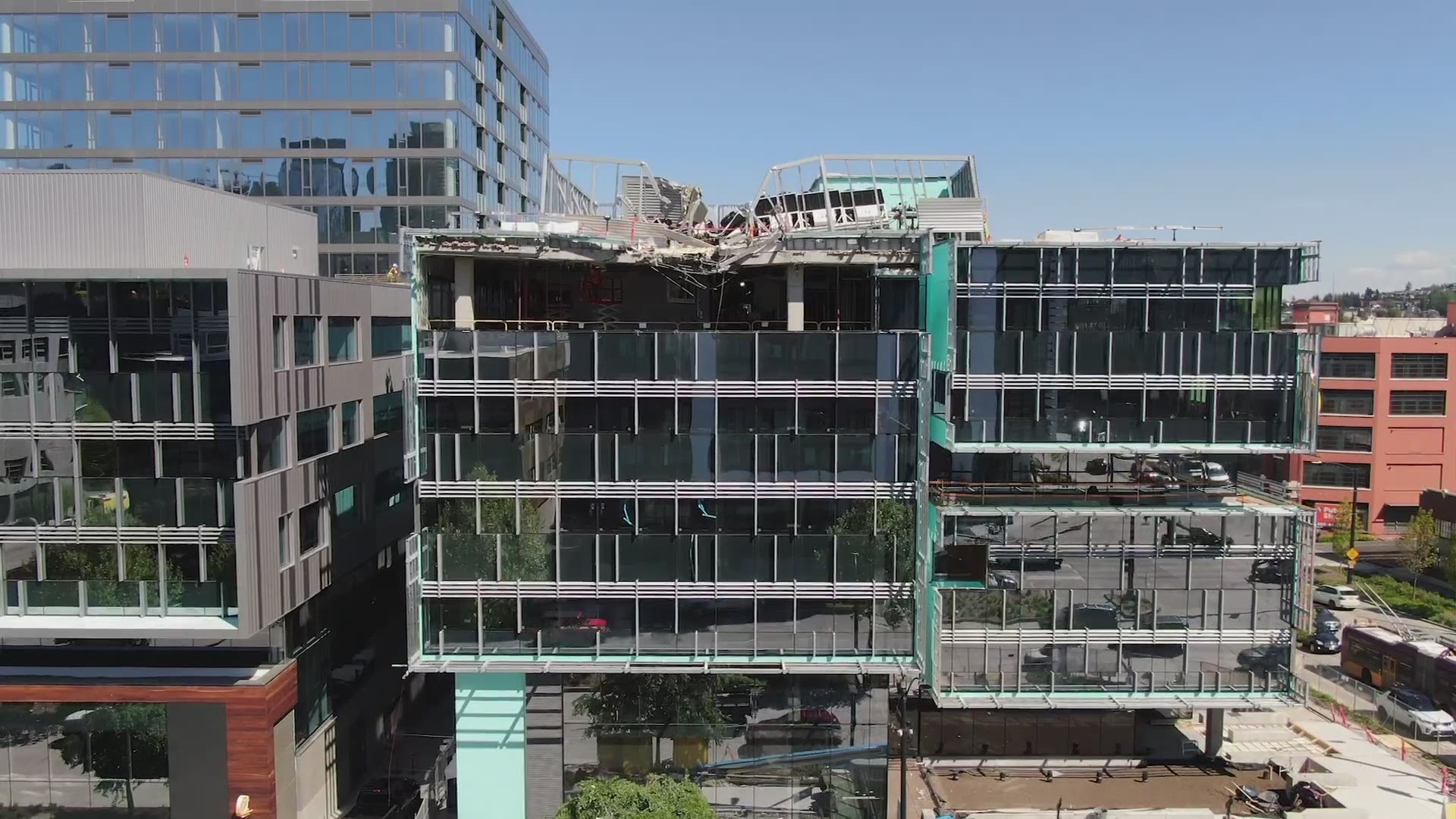 Drone video shows the damage left by a crane that collapsed - killing four people, and damaging a building under construction in downtown Seattle.