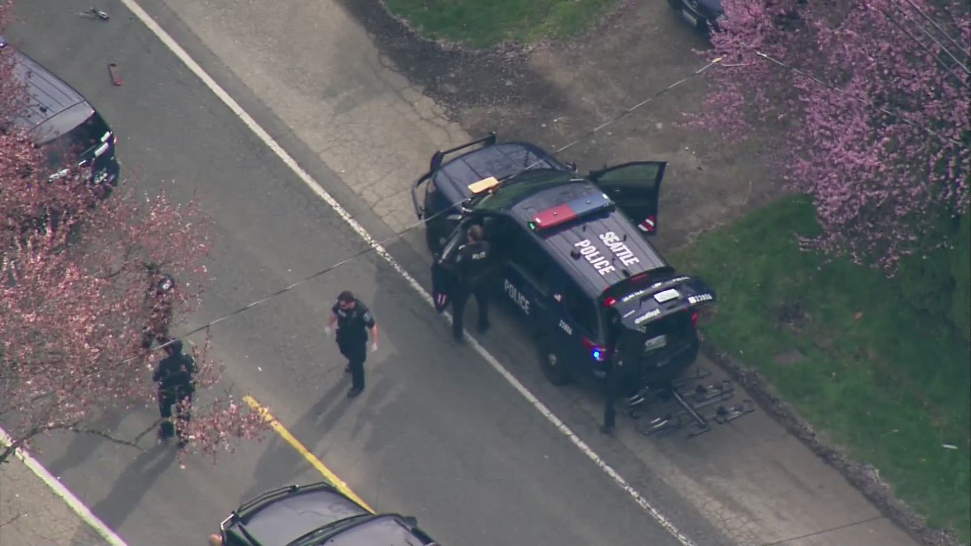 Police on scene of a shooting with multiple victims near 120th and Sandpoint Way in Seattle.