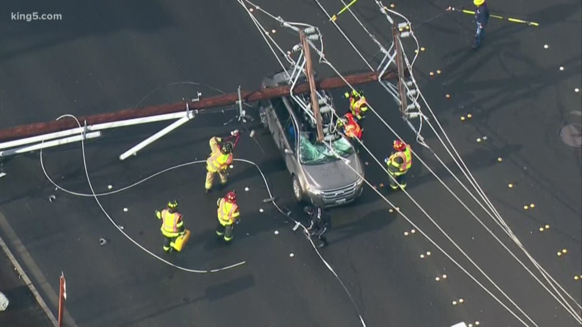 Two people were rescued after a power pole crashed into their SUV. A Seattle City Light officer said 24 power poles fell on a mile-long stretch of E. Marginal Way S. on Friday afternoon. KING 5's Natalie Swaby reports.