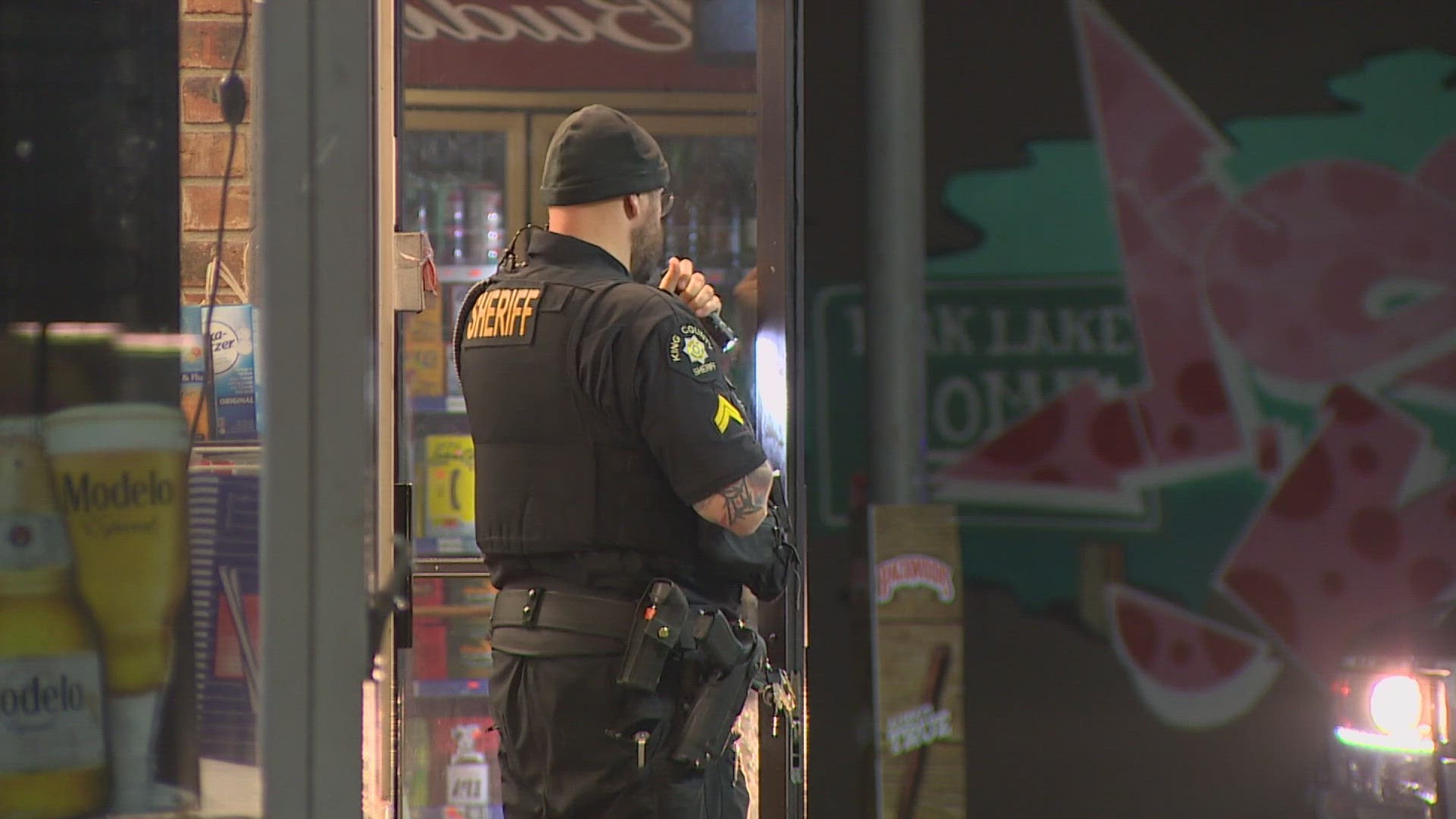 The clerk at a convenience store in Burien says suspects fired a shot at him during the incident.