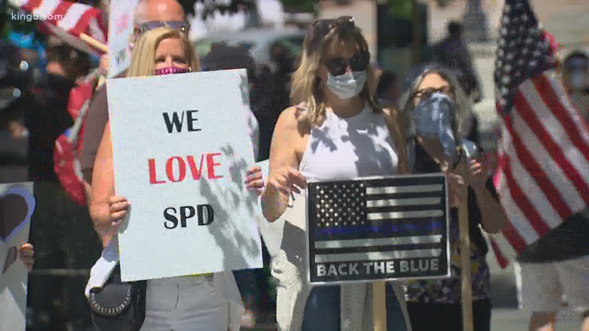 A group rallied outside Seattle City Hall Wednesday to show their support for police and keep funding for the department.