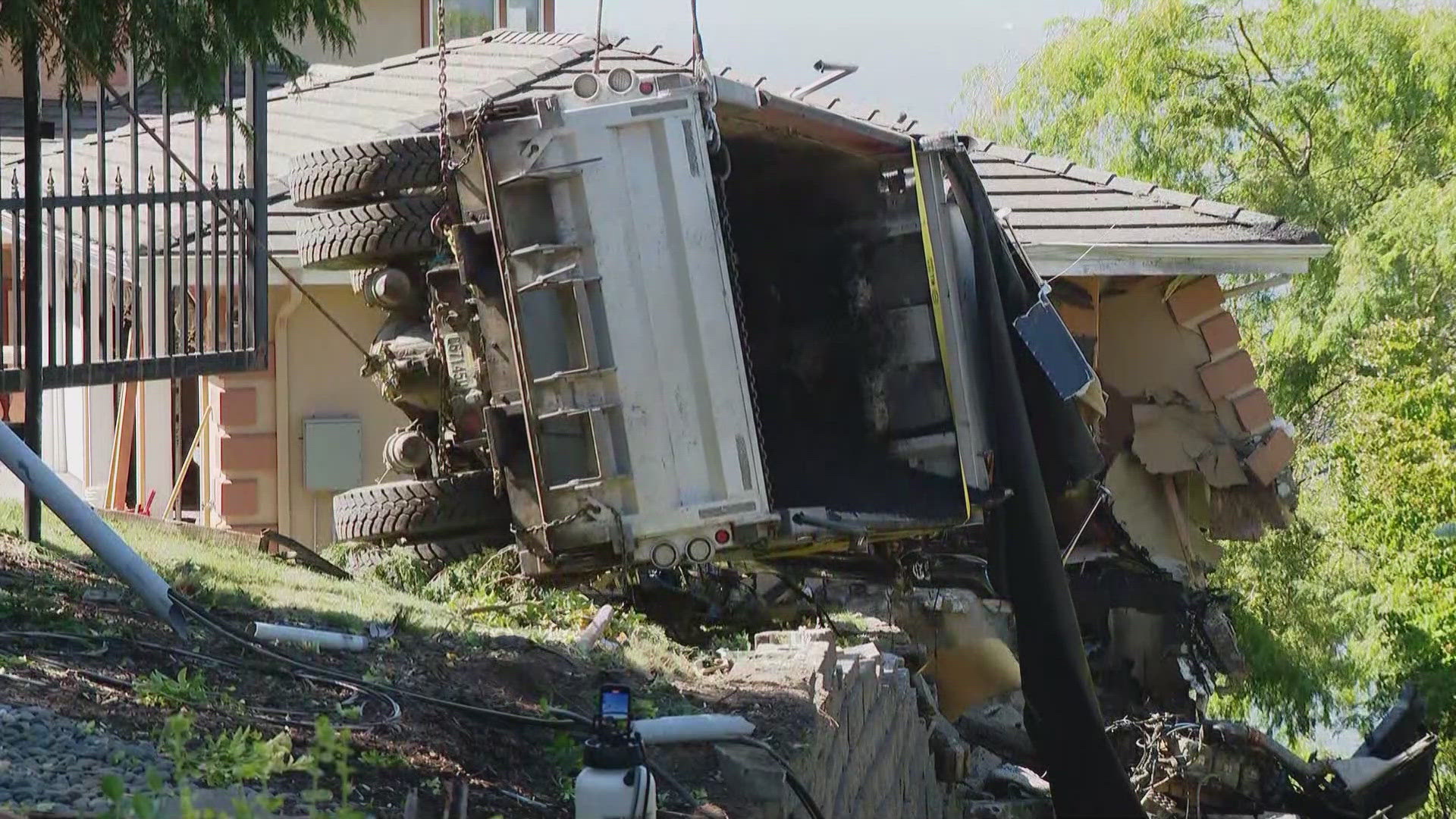 A driver is in the hospital in critical condition after an overturned dump truck crashed into an Edmonds home Wednesday morning.