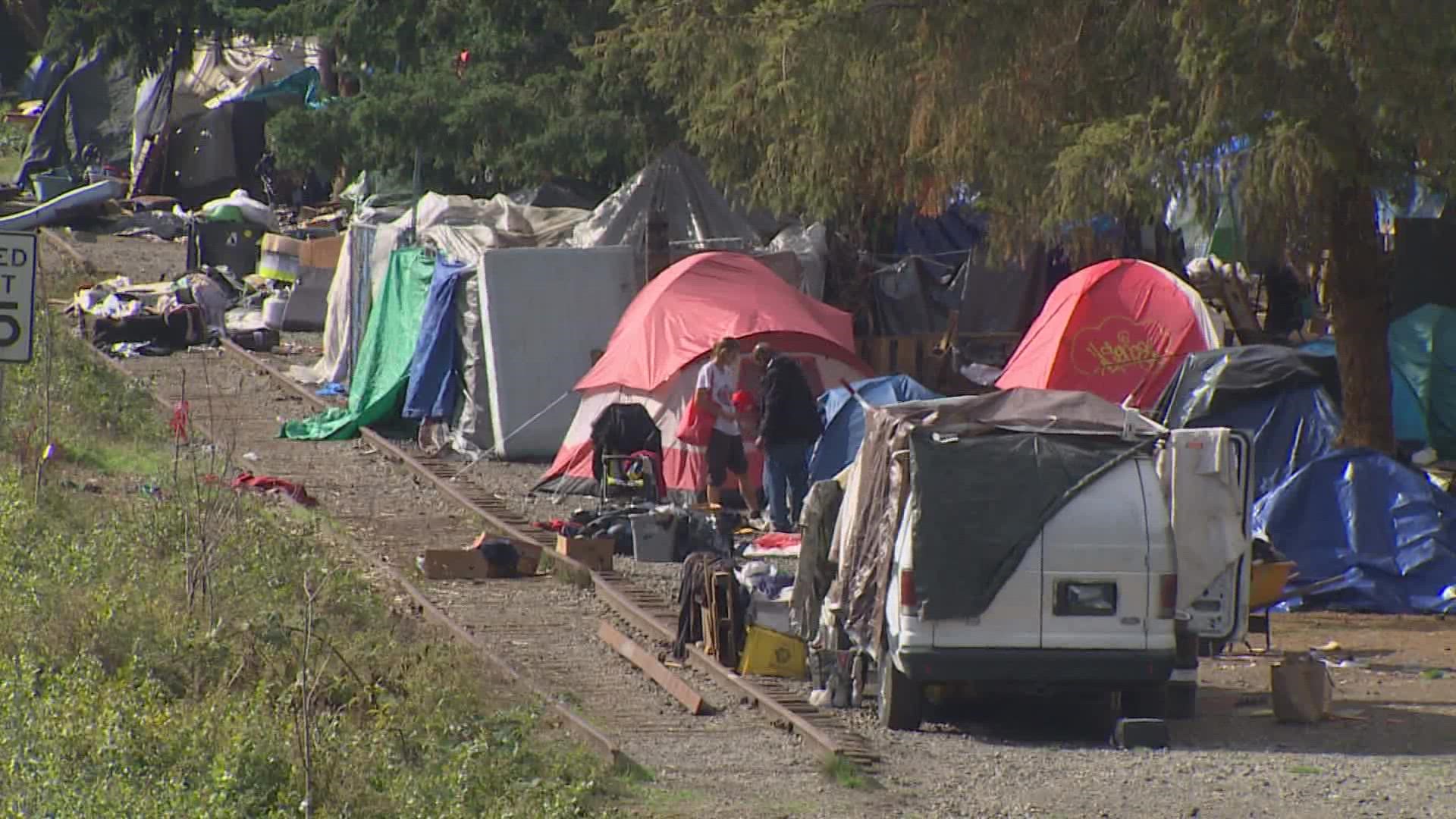 An Olympia man says residents of a nearby homeless encampment have used his water, electricity and someone broke into his home.