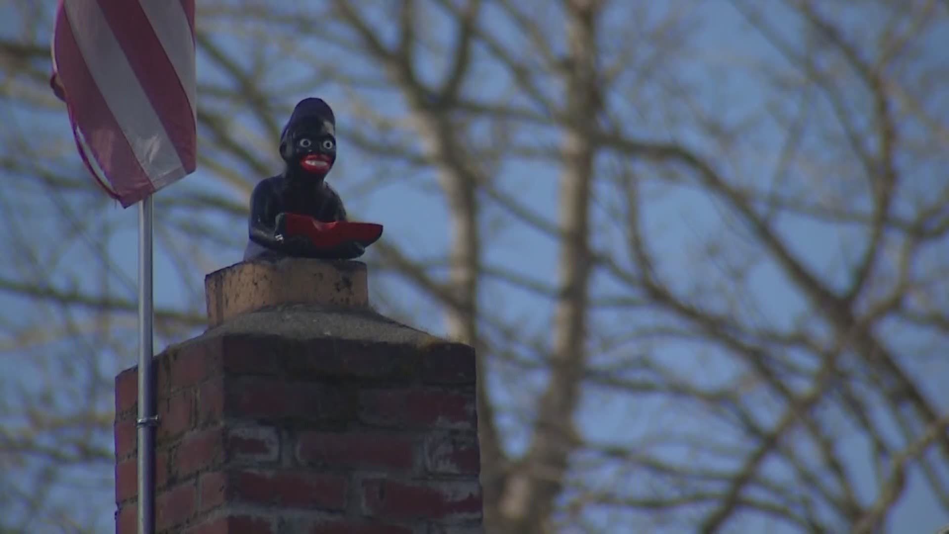 Calls for a commission to address racist incidents grew louder after a resident put up an offensive statue on a prominent street.